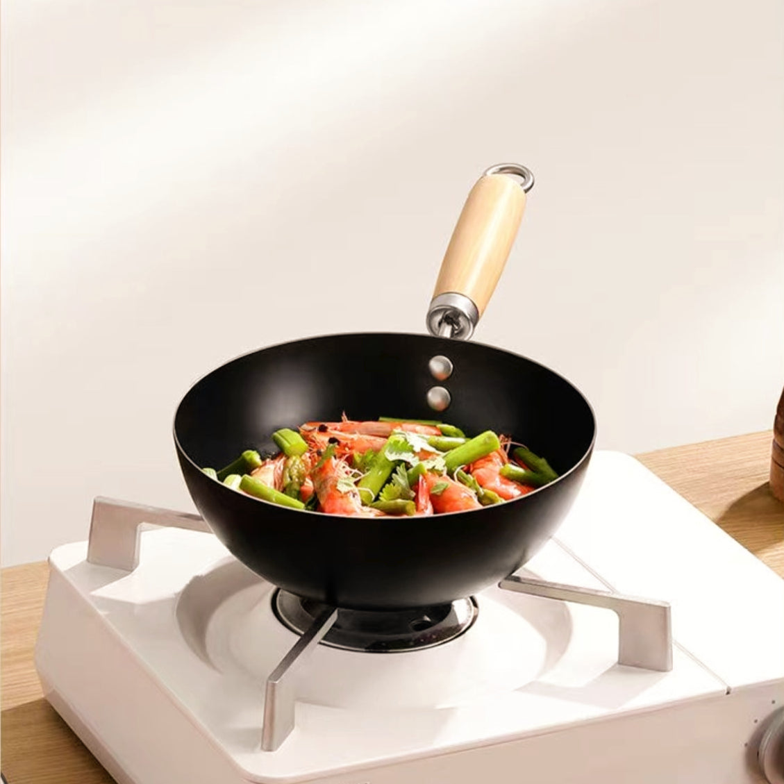 Black wok with vegetables on a stove