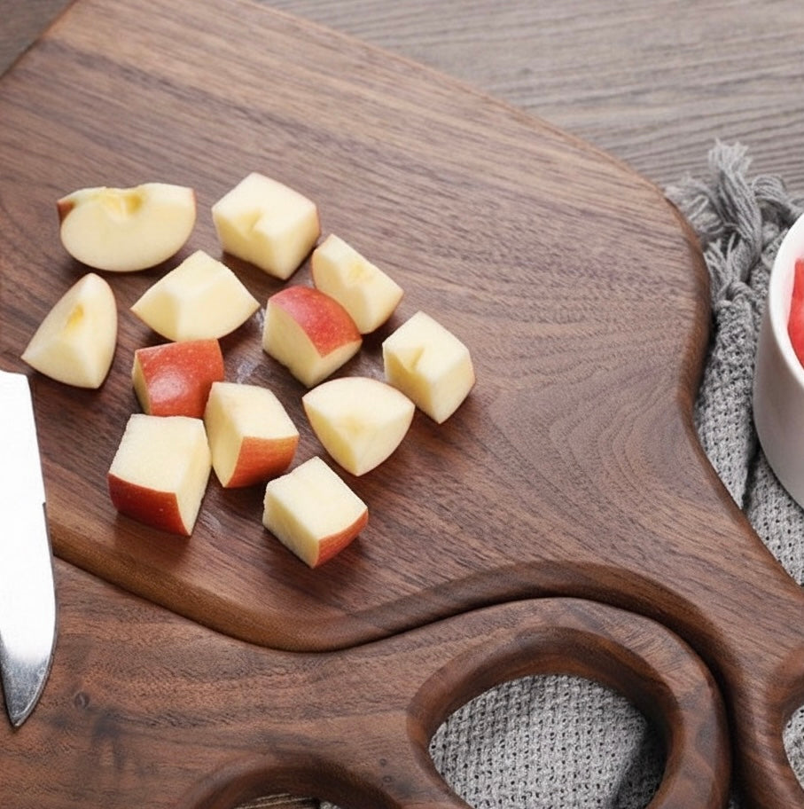 Diced apples on a wooden cutting board with a knife