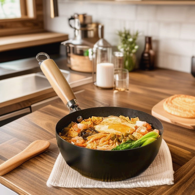 Frying pan with stir-fry on a kitchen counter